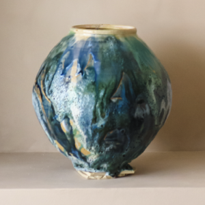 Håndlaget kunstvase med levende glasur i blå, grønne og turkise toner.
